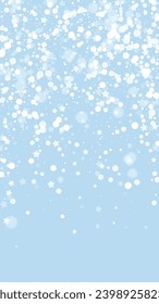 Snowy christmas background. Subtle flying snow flakes and stars on light blue winter backdrop. Delicate sweet snowy christmas. Vertical vector illustration.