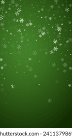 Snowy christmas background. Subtle flying snow flakes and stars on christmas green background. Delicate sweet snowy christmas. Vertical vector illustration.