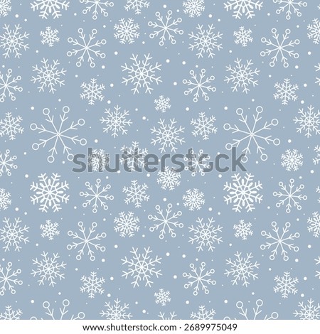 Snowy winter seamless pattern of hand drawn snow flakes on light blue background