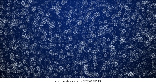Soap bubbles abstract background. Blowing bubbles on winter sky background. 