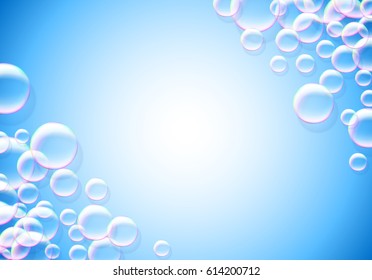 Soap bubbles blue background with rainbow colored airy foam