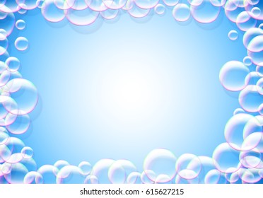 Soap bubbles blue background with rainbow colored airy foam