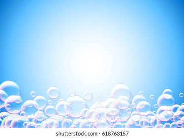 Soap bubbles blue background with rainbow colored airy foam