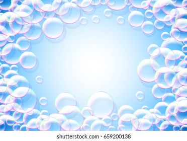Soap bubbles blue background with rainbow colored airy foam round frame