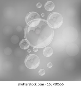 Soap bubbles on blurry gray background