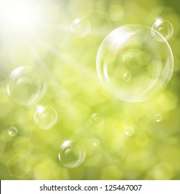 Soap bubbles on green natural background