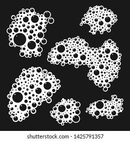 Soap bubbles and suds vector cartoon set isolated on black background.