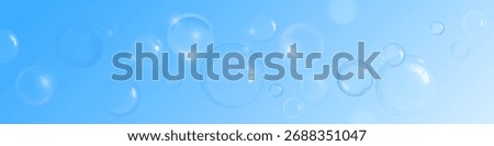 Soap or shampoo bubble background with transparent spheres and light reflections on soft blue gradient. Floating clean foam elements of various sizes in horizontal composition. Fresh hygiene theme.