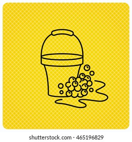 Soapy cleaning icon. Bucket with foam and bubbles sign. Linear icon on orange background. Vector