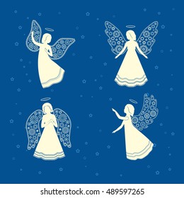 Soaring angels with ornamental floral wings and nimbus on a blue background. The praying angels on a background of sky and stars.