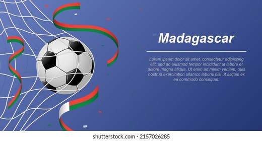 Soccer background with flying ribbons in colors of the flag of Madagascar. Realistic soccer ball in goal net.