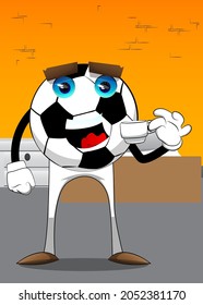 Soccer ball drinking coffee. Traditional football ball as a cartoon character with face.