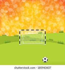 Soccer ball and gate with sunset background