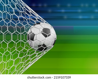 Soccer ball in goal net, side view. Goal moment of football match against stadium. Scoring a goal