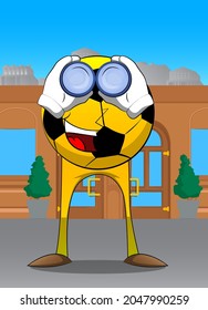 Soccer ball looking through binoculars. Traditional football ball as a cartoon character with face.