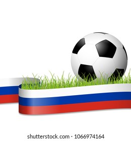 soccer ball lying in the grass with russian colors banner