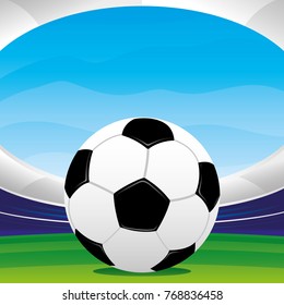 Soccer ball on the grass in the background of the stadium.