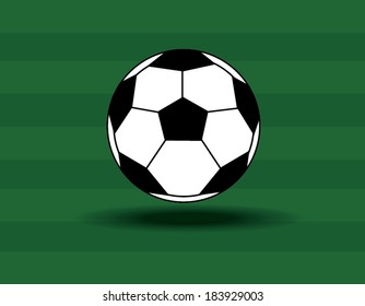 Soccer ball on the green grass background