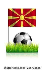 Soccer Ball on green grass field with flag of Republic of Macedonia