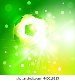 Soccer ball in the rays on a beautiful glowing  green background