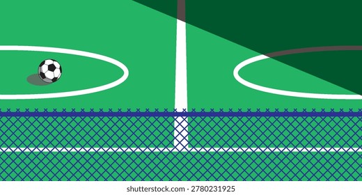 A soccer ball rests on a green sports field with white markings and a blue fence in the foreground.