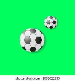 Soccer balls on a green background