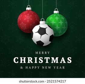 soccer Christmas Greeting card. Merry Christmas and happy new year sport greeting card. Hang on a thread green and red xmas ball bauble on green on background. Sport Vector illustration.