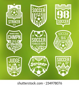 Soccer emblems in flat style. White print on a blurred background