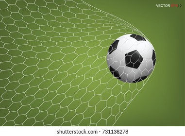 Soccer football ball in goal with white net and green field background. Vector illustration.