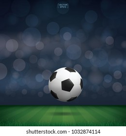 Soccer football ball in green grass of soccer field or football field stadium background. Vector illustration.