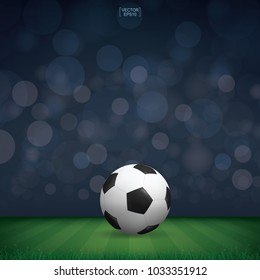Soccer football ball in green grass of soccer field or football field stadium background. Vector illustration.