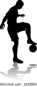 A soccer or football player in silhouette 