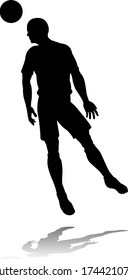 A soccer or football player in silhouette 