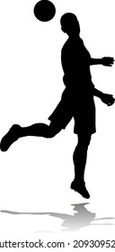 A soccer or football player in silhouette 
