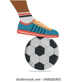 A soccer player in sports shoes and a soccer ball.