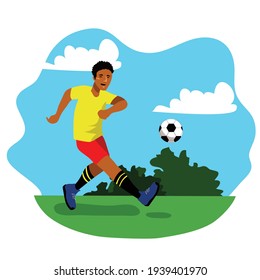 Soccer player in sports uniform kicking a football. Look so happy. Blue sky in the background. It’s fit for promoting man sport, active and healthy lifestyle.
