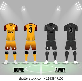 Soccer uniforms in yellow and black on soccer field and spotlight