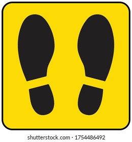 Concepto de distanciamiento social para prevenir el coronavirus covid-19 con huella negra en fondo amarillo