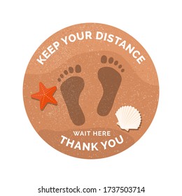 Social distancing and coronavirus covid-19 prevention: floor sticker sign with footprints on the beach sand
