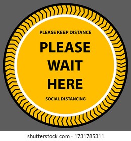 Social distancing queue sign. Please wait here round sign printed on ground at supermarket cash desk register informing people to keep 2 meter 6 feet distance to prevent Coronavirus spreading 