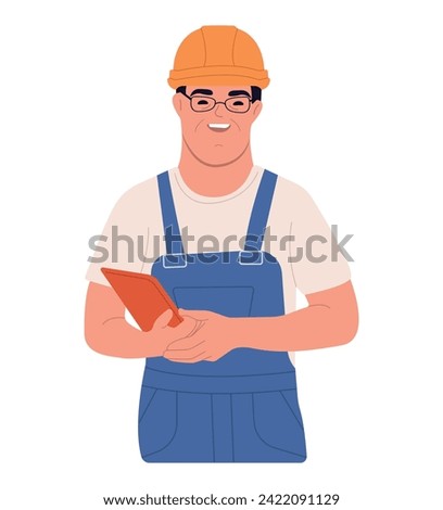Social integration concept. A happy man with down syndrome is standing in a helmet and suit. A young man with Down syndrome works in an industrial enterprise.
