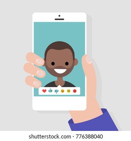 Social media icons. Reactions: thumbs up, thumbs down, emoji. Rate the photo. Millennial character. Hand holding a smartphone. Flat editable vector illustration, clip art