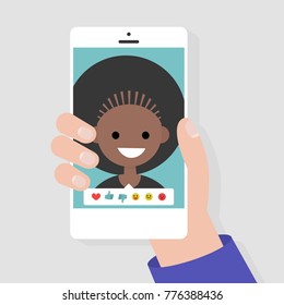 Social media icons. Reactions: thumbs up, thumbs down, emoji. Rate the photo. Millennial character. Hand holding a smartphone. Flat editable vector illustration, clip art
