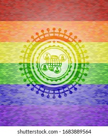 ícono de red social dentro del emblema sobre fondo de mosaico con los colores de la bandera LGBT
