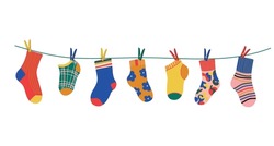 Socks On A Rope With Colored Clothespins. Dry A Cotton Or Wool Sock And Hang It On A Clothesline With Clothespins. Baby Socks With Textures And Patterns Vector Cartoon. Illustration Of Woolen And Cott
