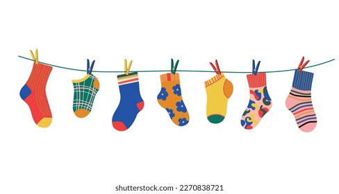 Socks on a rope with colored clothespins. Dry a cotton or wool sock and hang it on a clothesline with clothespins. Baby socks with textures and patterns vector cartoon. Illustration of woolen and cott