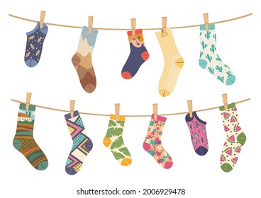 Socks on rope. Cotton sock with cute pattern hanging and drying on laundry ropes. Various funny socks with clothespins vector illustration. Different trend designs for man and woman