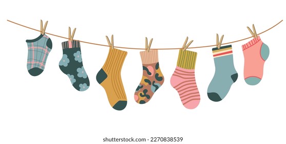 Socks on rope. Cotton or wool sock dry and hang on laundry string with clothespins. Children socks with textures and patterns vector cartoon. Illustration wool and cotton socks in rope