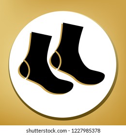 Socks sign. Vector. Black icon with light brown shadow in white circle with shaped ring at golden background.
