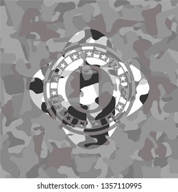soda can icon inside grey camouflage emblem
